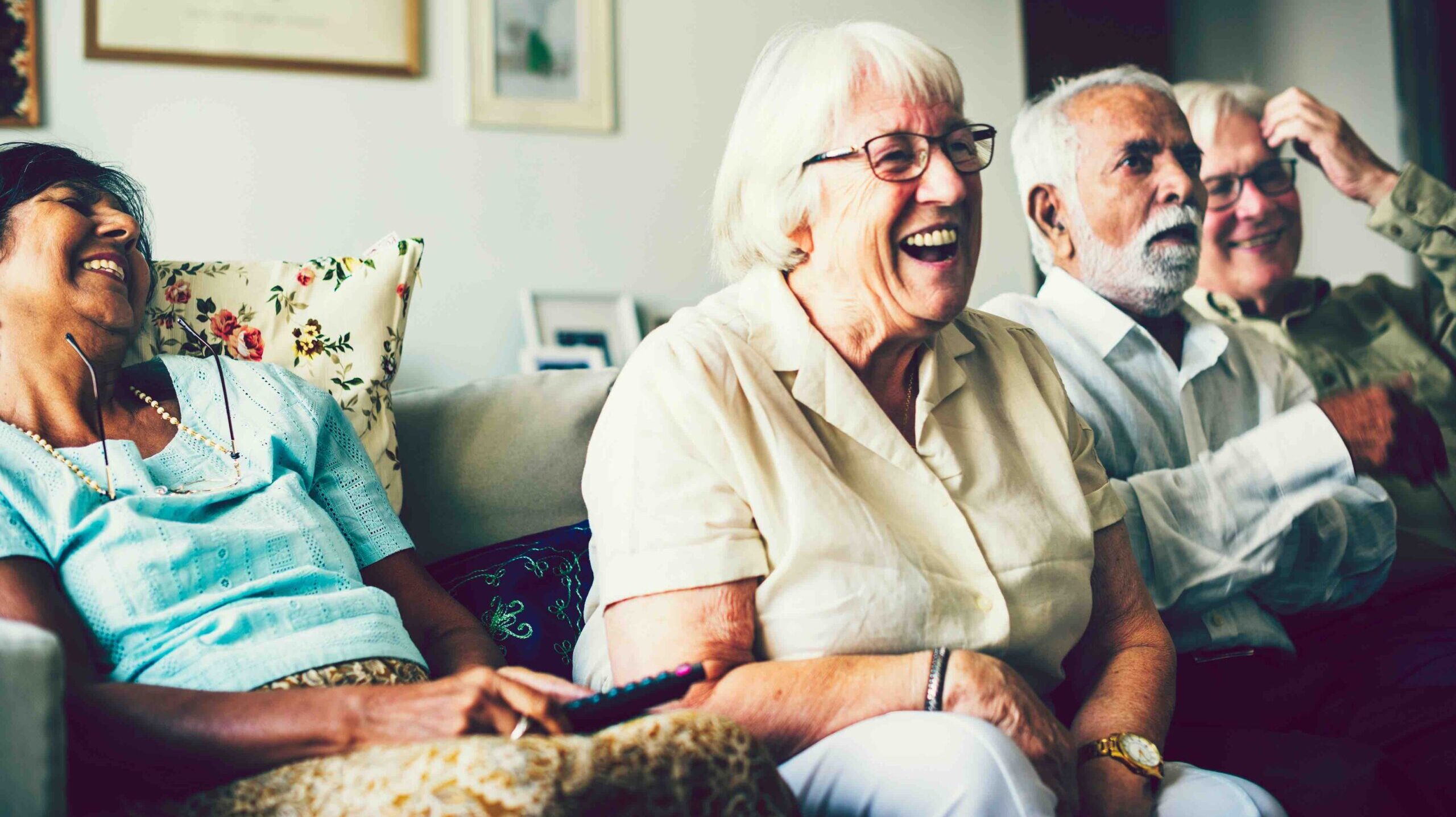 Senior people watching television in the living room