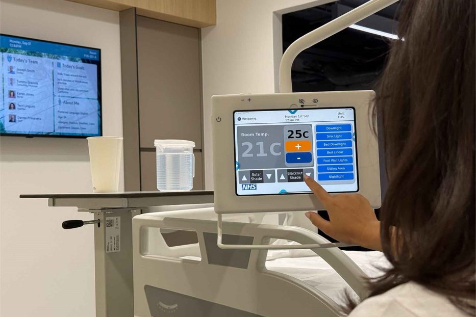 Future Healthspaces: Digital Healthcare in the NHS Room of the Future Patient using digital bedside screen in a future healthspaces NHS room with advanced hospital technology.